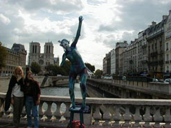 Students Pose By Statue On Bridge Over Seine