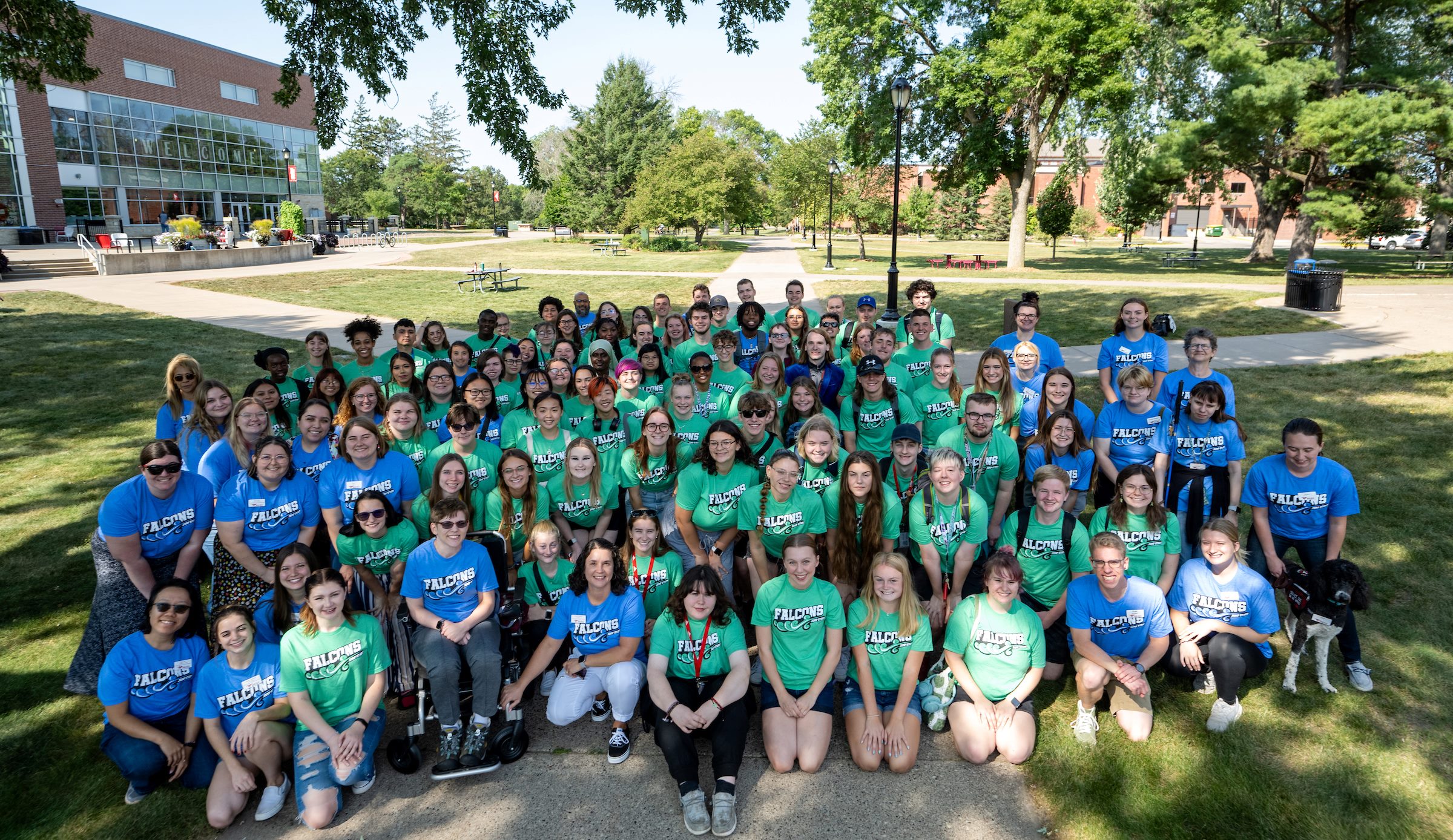 A large group of students and staff in blue and green t-shirts