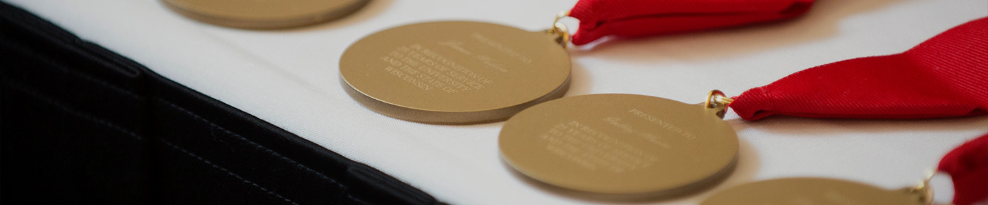 Several medals are lined up on a table