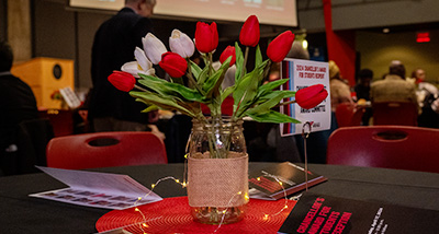 A vase of red and white tulips sits on a table during the Chancellors Awards ceremony in the Falcons Nest University Center