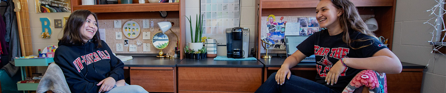 Two female students sitting in their dorm room